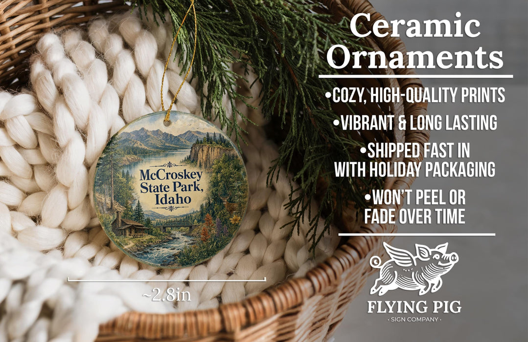 Ceramic ornaments, featuring a scenic image of McCrokey State Park, Idaho, hanging from a wicker basket.