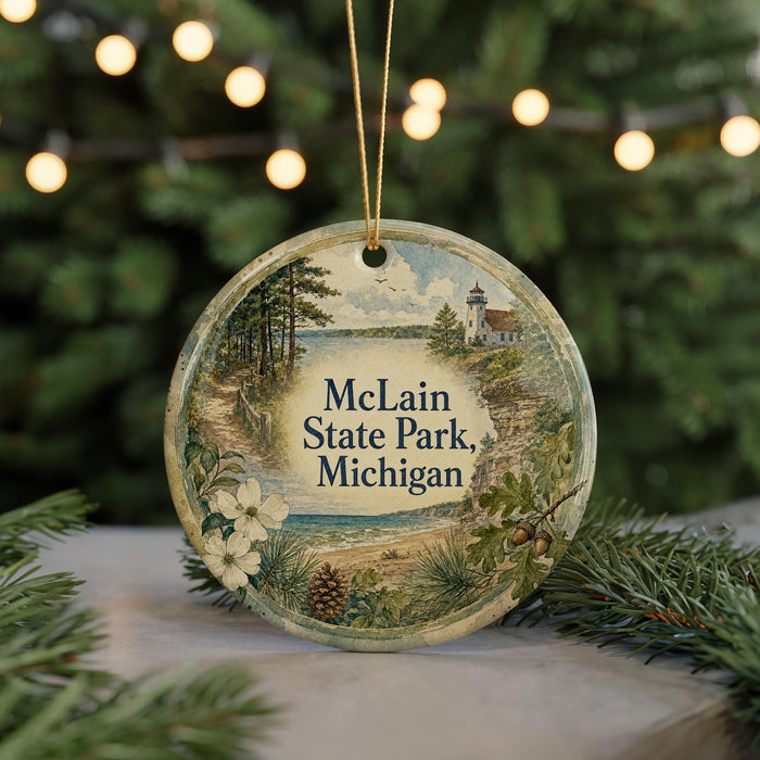 A round ornament with a scenic landscape of a lake, lighthouse, and trees, featuring the text "McLain State Park, Michigan" on it.