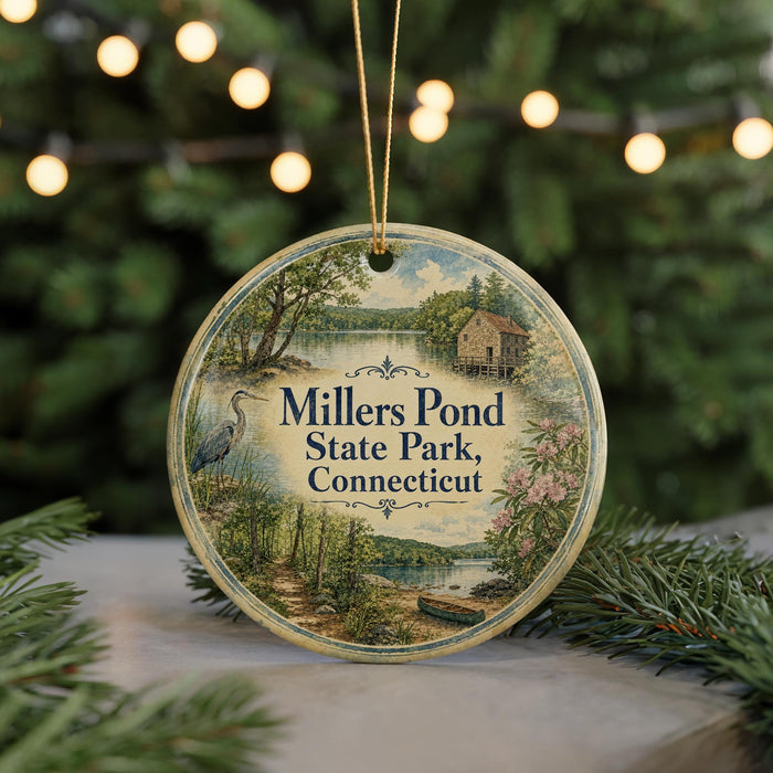 A round ornament with a scenic image of Millers Pond State Park, Connecticut, featuring a lake, trees, and a bird.