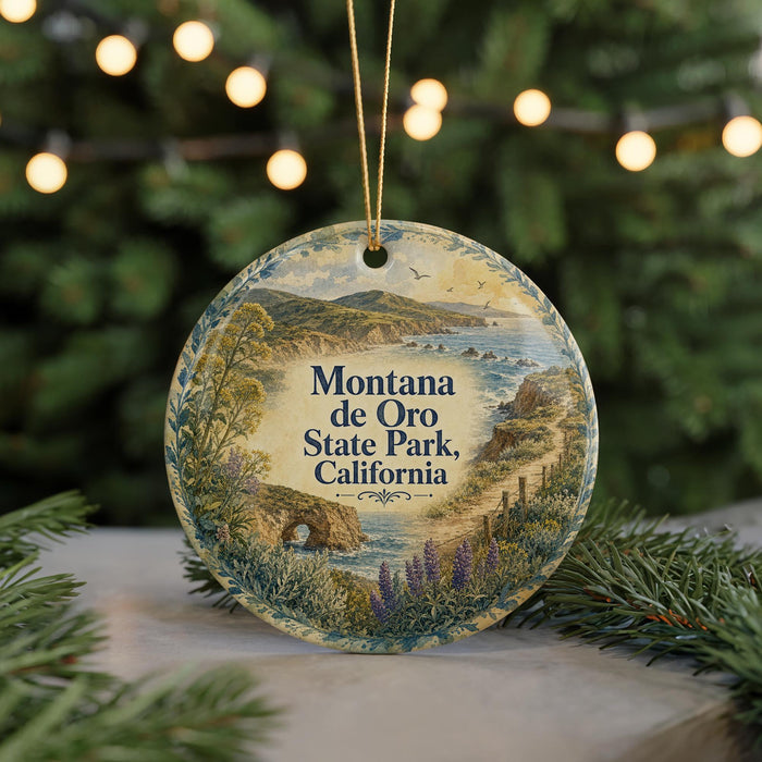 A decorative ornament featuring a scenic landscape of Montana de Oro State Park, California, with a string of lights in the background.