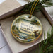 A decorative ornament featuring a moose and a scenic landscape, with the text "Moose Lake State Park, Minnesota" displayed on it.