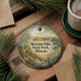 A round ornament with a scenic landscape of Moraine Hills State Park, Illinois, featuring a winding path, trees, and a lake.
