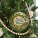 A Christmas tree decorated with ornaments, including a circular ornament with the text "Mounds State Park, Indiana" and a wooden bead decoration.