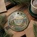 A decorative ornament featuring a scenic landscape of Mount Neb, Arkansas, with a cabin and trees in the background.