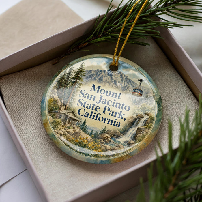 A decorative ornament with a scenic landscape of mountains, waterfalls, and a cabin, featuring the text "Mount San Jacinto State Park, California".