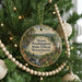 A round ornament hanging on a Christmas tree, featuring a scenic landscape of the Mount Washington State Forest in Massachusetts.