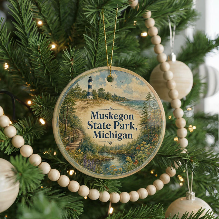 A round ornament hanging on a Christmas tree, featuring a lighthouse and a scenic landscape.