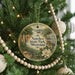 A round ornament hanging on a Christmas tree, featuring a scenic image of Natchez State Park, Mississippi.
