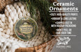 Ceramic ornaments, featuring a natural bridge in Massachusetts, are displayed in a basket with greenery.