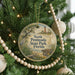 A round ornament hanging on a Christmas tree, featuring a scenic image of the North Peninsula State Park in Florida.