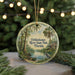 A circular ornament featuring a painting of a river, palm trees, and a bird, with the text "Ochlockonee River State Park, Florida" displayed on it.