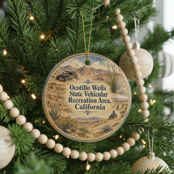 A circular ornament hanging on a Christmas tree, featuring a desert landscape with a vehicle and mountains in the background.