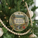 A Christmas tree decorated with ornaments, including a circular ornament with a scenic mountain landscape and text that reads "October Mountain State Forest, Massachusetts".