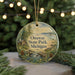 A round ornament with a scenic landscape of Onaway State Park, Michigan, featuring a cabin, pine trees, and a waterfall.