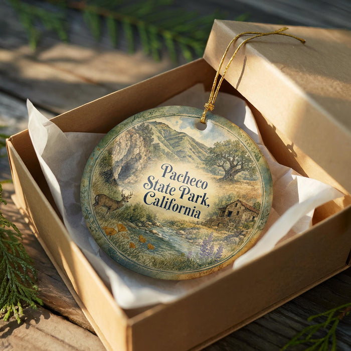 A decorative ornament in a wooden box, featuring a scenic landscape with mountains, trees, and a river.