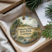 A decorative ornament with a palm tree and a bird, featuring the text "Palmetto Island State Park, Louisiana" on it, placed in a box with pine branches.