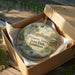 A decorative ornament in a box, featuring a scenic image of Palmetto Island State Park in Louisiana.
