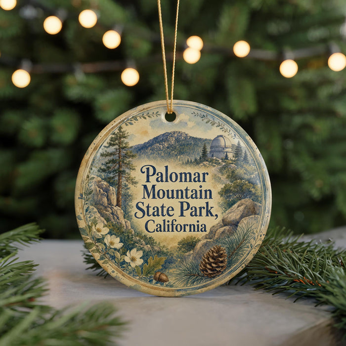 A round ornament with a scenic mountain landscape and pine trees, featuring the text "Palomar Mountain State Park, California".