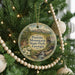 A round ornament hanging on a Christmas tree, featuring a scenic image of Panola Mountain State Park in Georgia.