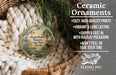 Ceramic ornaments, featuring a bird and palm tree design, are displayed in a basket with greenery.