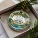 A decorative ornament in a box, featuring a peacock and the text "Peacock Springs State Park, Florida".