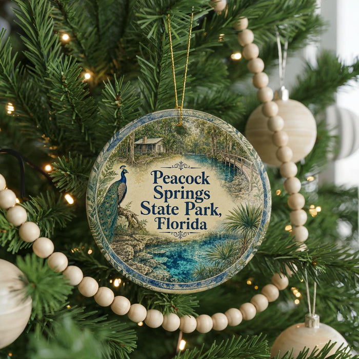 A round ornament hanging on a Christmas tree, featuring a peacock and the text "Peacock Springs State Park, Florida".