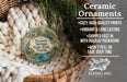 Ceramic ornaments, featuring a round ornament with a peacock and palm tree design, hanging from a wicker basket.