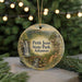A round ornament with a scenic image of Petit Jean State Park, Arkansas, hanging from a string.