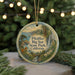 A round ornament with a scenic landscape of Big Sur State Park, California, featuring a mountain, river, and pine trees.