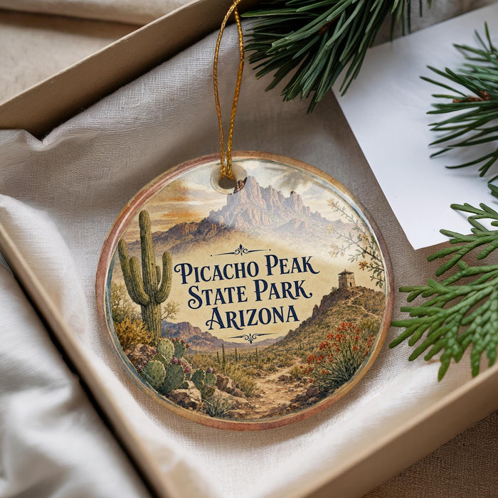 A decorative ornament with a desert landscape and mountains, featuring the text "PICACHO PEAK STATE PARK ARIZONA" on it.