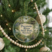 A round ornament hanging on a Christmas tree, featuring a scenic image of the Potomoke River State Park in Maryland.