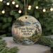 A round ornament with a scenic landscape of Point Bridget State Park, Alaska, featuring a mountain range, a river, and a bird of prey.