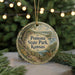 A round ornament with a scenic landscape of Pomona State Park, Kansas, featuring a path, a river, and a bird in flight.