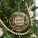 A round ornament hanging on a Christmas tree, featuring a scenic image of Porcupine Mountains Wilderness State Park, Michigan.