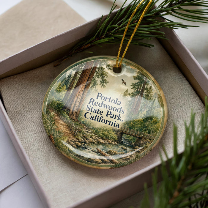 A decorative ornament with a scenic image of Portola Redwoods State Park in California, featuring a forest landscape with a stream and bridge.