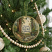 A round ornament hanging on a Christmas tree, featuring a scenic image of Portola Redwoods State Park, California.