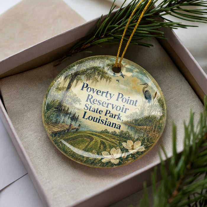 A decorative ornament with a landscape scene featuring a pond, trees, and flowers, along with text that reads "Poverty Point Reservoir State Park Louisiana".