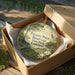 A wooden box containing a decorative ornament with a landscape scene and text that reads "Poverty Point Reservoir State Park Louisiana".