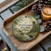 A wooden tray with a decorative ornament featuring a scenic landscape of Prophetstown State Park, Indiana, and a small boat on a river.