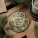 A decorative ornament with the text "Pumpkin Hill Creek Preserve State Park, Florida" is displayed on a wooden surface, surrounded by pine branches and a cup of coffee.