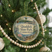 A round ornament on a Christmas tree, featuring a scenic image of Quad Dick State Park in Connecticut.