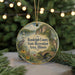 A decorative ornament featuring a scenic landscape with a lake, bridge, and wildlife, including a crane, against a backdrop of greenery and a string of lights.