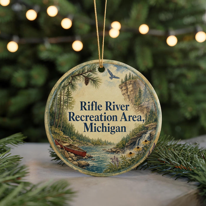 A round ornament with a scenic image of a river, pine trees, and a waterfall, along with the text "Rifle River Recreation Area, Michigan".