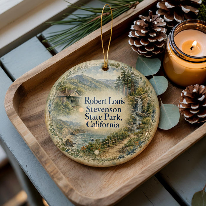A wooden tray with a decorative ornament featuring a scenic landscape, including mountains, a river, and pine trees. The ornament also includes the text "Robert Louis Stevenson State Park, California".