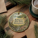 A decorative ornament featuring a scenic landscape of Robinson State Park, Massachusetts, with a tower and a river, hanging on a wooden surface.