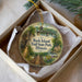 A decorative ornament in a box, featuring a scenic image of Rock Island Trail State Park in Illinois.
