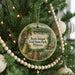 A round ornament hanging on a Christmas tree, featuring a scenic image of Rock Island Trail State Park, Illinois.