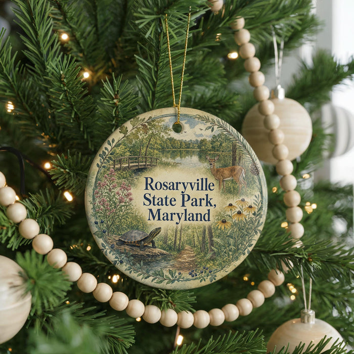 A round ornament hanging on a Christmas tree, featuring a scenic image of Rosaryville State Park, Maryland.