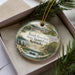 A decorative ornament with a scenic view of Rough River Dam, State Resort Park, and Kentucky, featuring a lake, boats, and a bridge.
