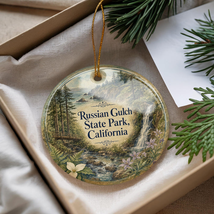 A decorative ornament with a scenic landscape of Russian Gulch State Park, California, featuring a waterfall, pine trees, and a meadow.